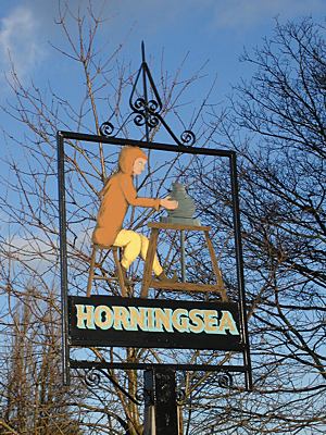 Horningsea village sign showing a potter at work
